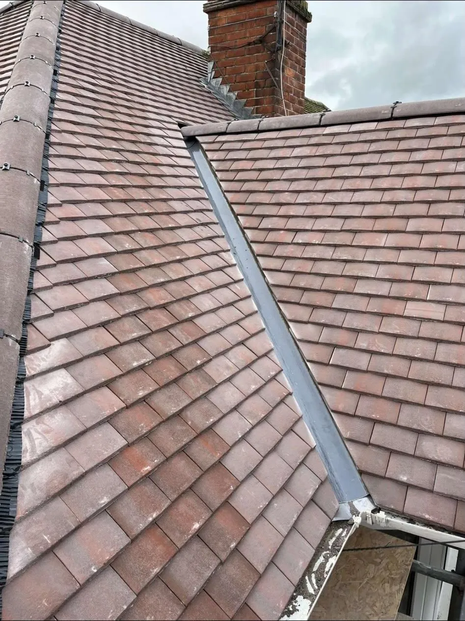 New lead valley and ridge tiles on a tiled roof